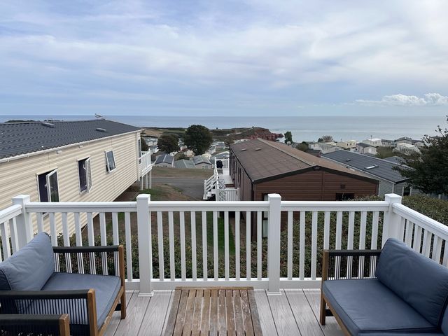 A deck with chairs overlooking the ocean at Club Sahara in Sandy Bay, Exmouth