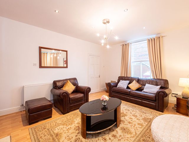 A living room with a sofa and coffee table at 5 Bed House, sleeping 10 in the City Centre, Liverpool