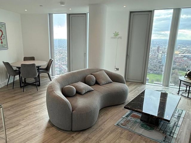 A living room with a sofa and dining area at 3 Bed Apartment, sleeping 6 with Wifi, Manchester