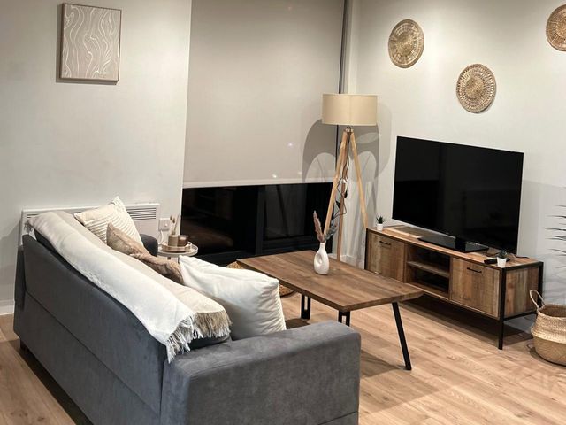 A living room with a sofa and television at Central Apartment with Free Parking, Terrace and Gym in Manchester