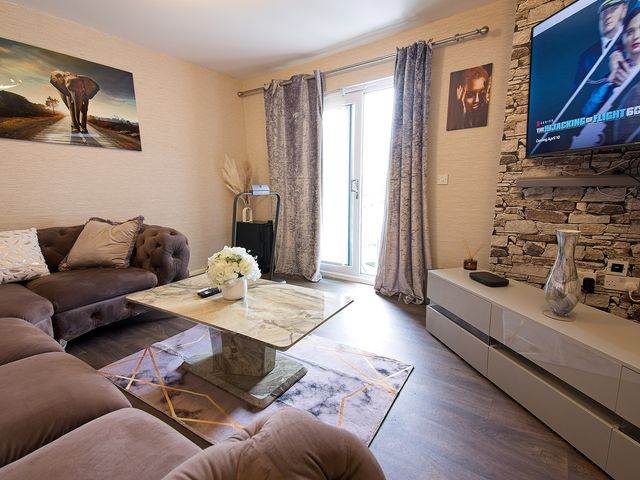 A living room with a sofa and coffee table at 2 Bedroom Apartment in Manchester