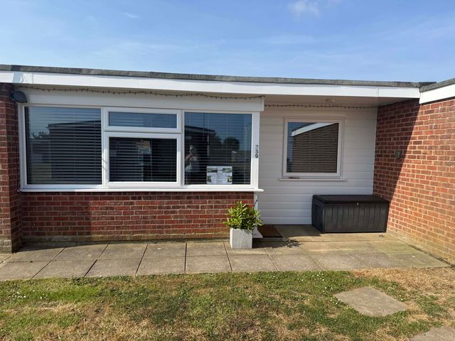 Exterior view of a property with windows and a storage box at Chalet 359 Hemsby