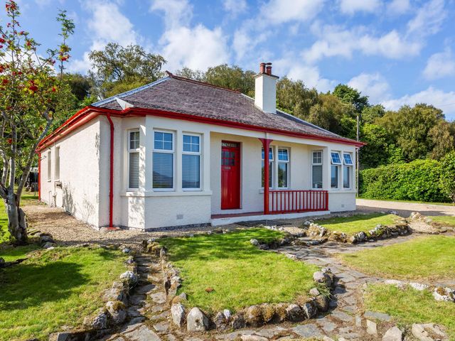 A house with a red door and pathway at Fereneze, Lochranza, Isle Of Arran