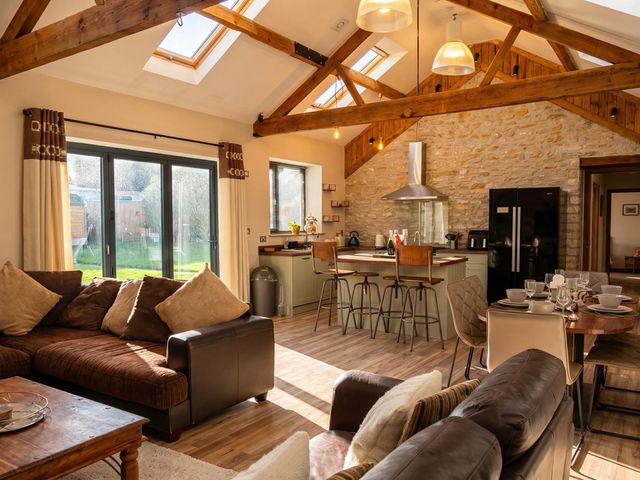 A living room with a kitchen and dining area at 