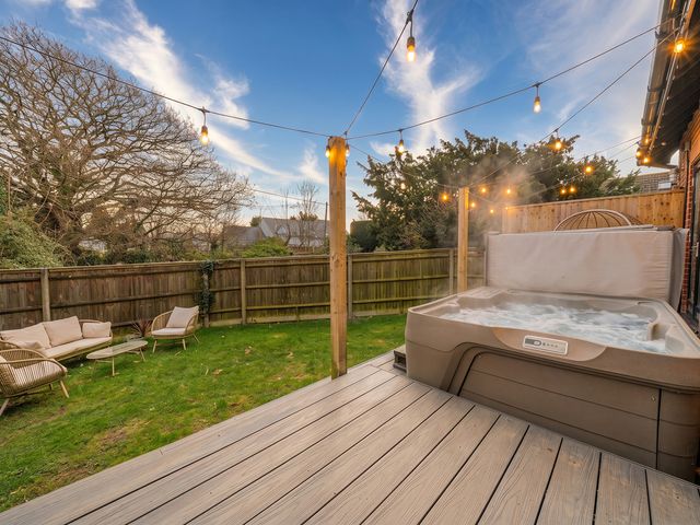 A garden with a hot tub and outdoor seating at a property