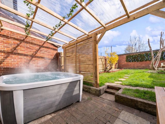 A garden with a hot tub and pathway at the property in location