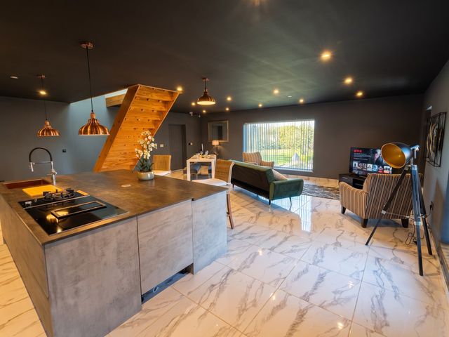 A living room with a kitchen island and sofa at The Old Barn in Manchester