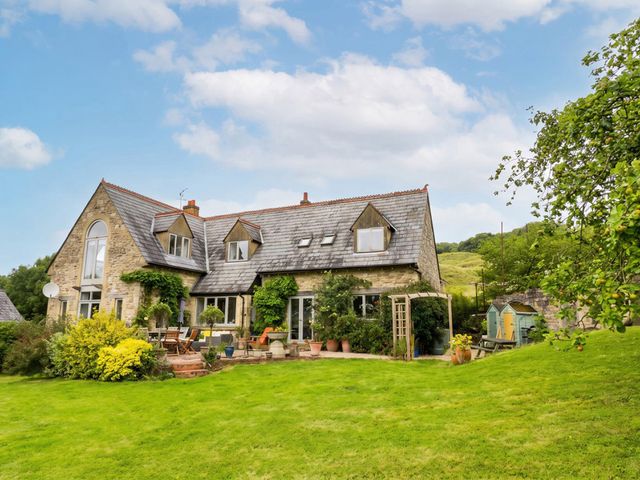 A house with a garden and patio area at the property in unspecified location