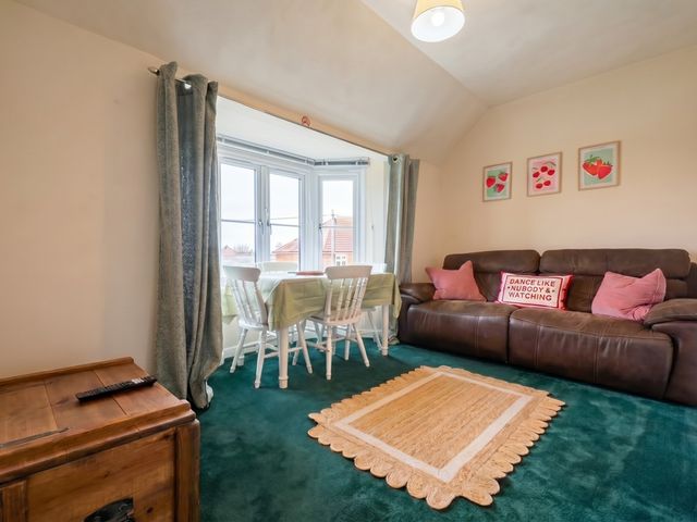 A living room with a dining area and sofa at The Old Barn in Manchester
