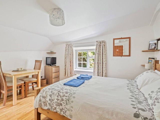 A bedroom with a bed and dining table at Old Post Office