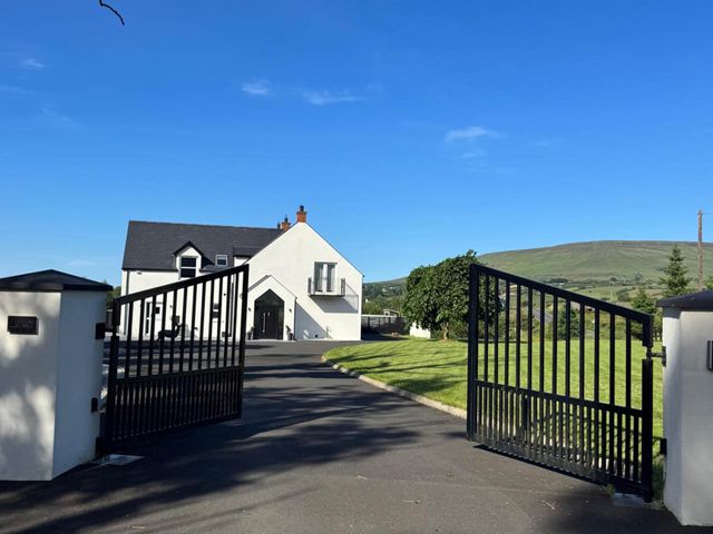 A house with gated entrance and driveway at Jeannies retreat at little lake fb