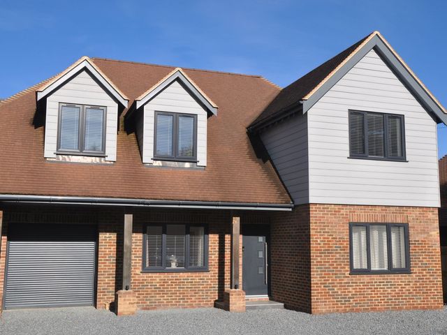 A house with windows and a garage at Berisal in Ashford