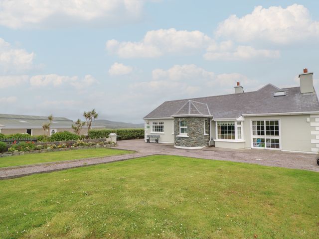 A house with a garden and pathway at Wild Atlantic Way Country Cottage in Portmagee, County Kerry