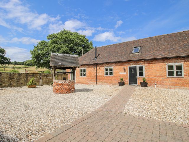 An outdoor area with a well and pathway at The Milking Parlour in Westhope