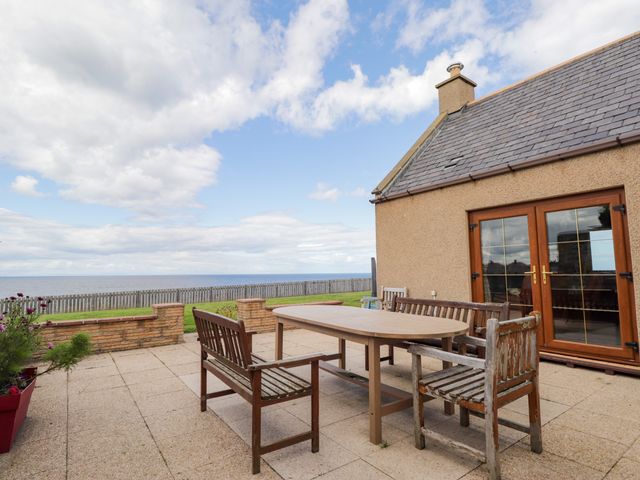 An outdoor patio with table and chairs at Braehead Croft Portessie near Buckie