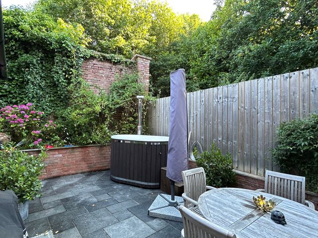 A garden with a hot tub and seating area at Treetops in Southerton near Sidmouth