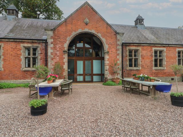 An outdoor area with tables and plants at Diamond Lodge Ingestre near Great Haywood