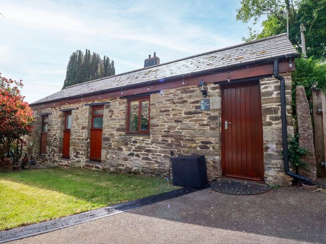 A stone building with windows and a door at Cosy Cottage in Dobwalls