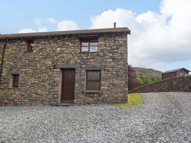 An outdoor view of a stone cottage at Copper Beech Cottage in Torver