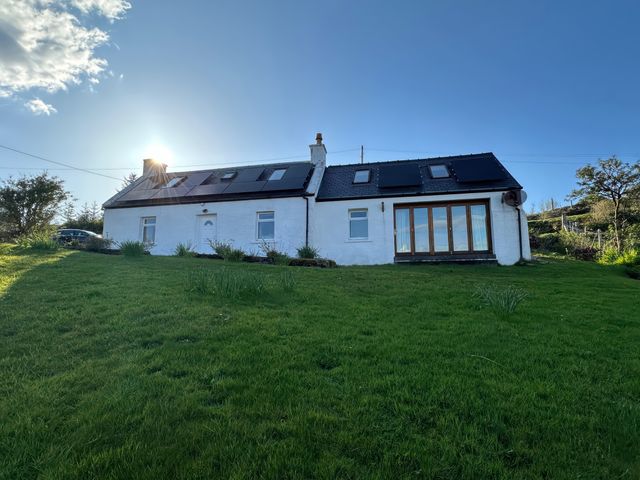 A house with a garden and windows at Solas in Broadford