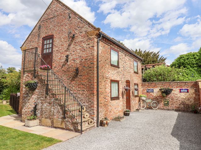 A brick building with stairs and bicycle at Croft Granary Stillington near Easingwold and York
