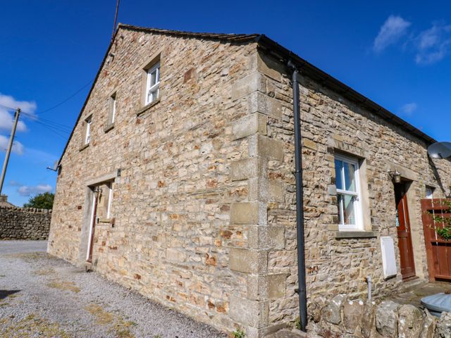 A stone house with windows and a door at Barnbrook in Carperby near Leyburn