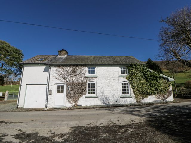 An exterior view of a house with ivy on the wall at Penlone Cottage Rhayader