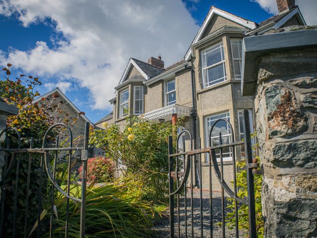 A house with a garden and gate at The Farm House in Bala