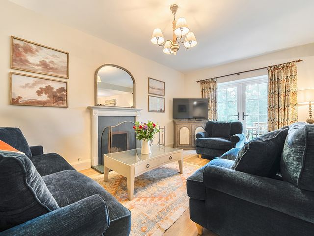 A living room with a sofa and television at Jubilee at the Graythwaite Estate in Graythwaite near Hawkshead