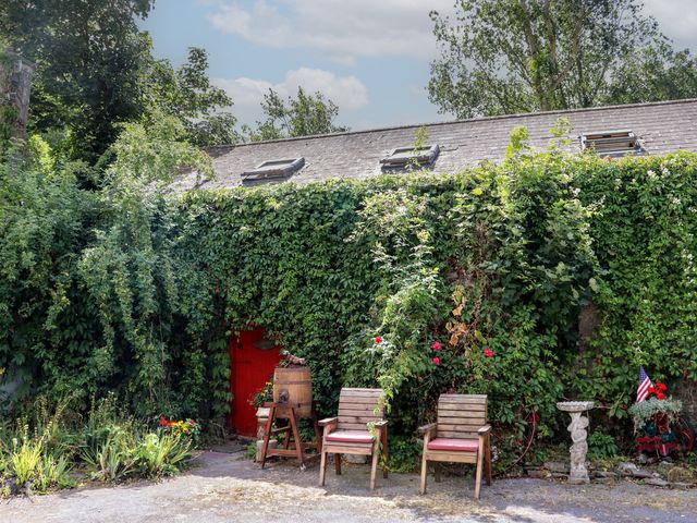 An outdoor seating area with chairs and a red door at Ryan's Loft, Ardfinnan near Clonmel, County Tipperary