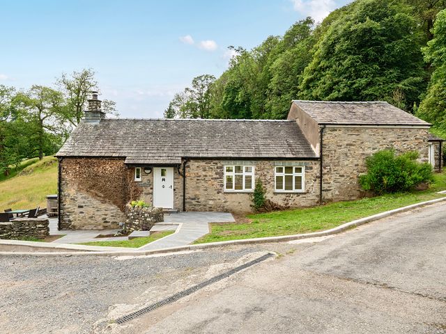 A cottage with a pathway and garden at Dove Cottage at the Graythwaite Estate Graythwaite Estate near Hawkshead
