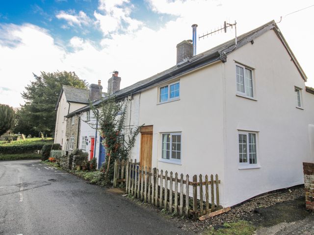 A cottage with a fence and a road at Marigold Cottage Clun near Bishop's Castle