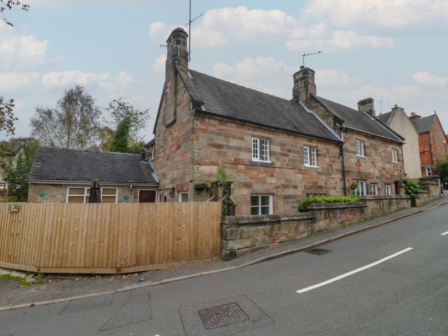 A house with a fence and trees on a street at Ash House in Alton near Alton Towers
