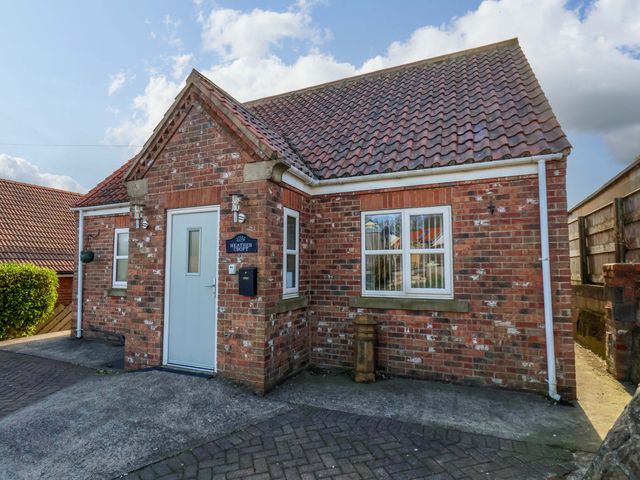 A house with a door and windows at Heather Croft in Robin Hood's Bay