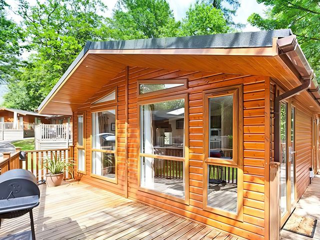 A log cabin with deck and grill at Beech Hill Lodge (Beech Hill 9) at Fallbarrow Park