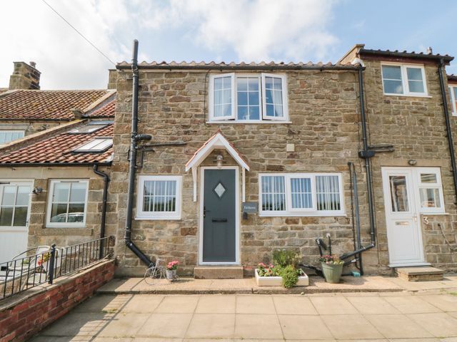 A stone house with a front door and windows at Fairhaven Cottage Ugthorpe near Runswick Bay