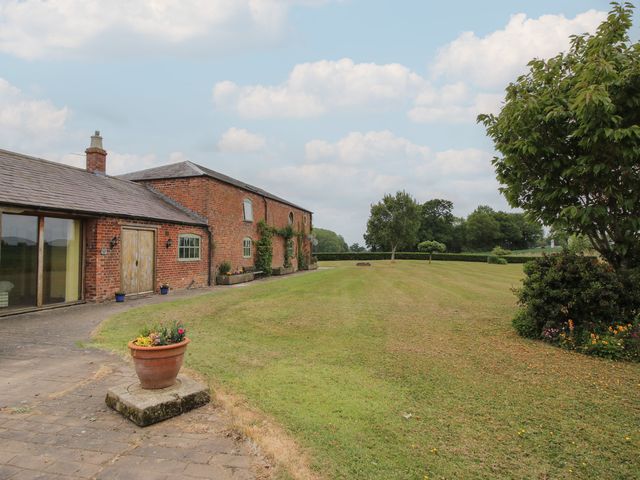 An outdoor view of a garden and house at The Barn Cockshutt near Ellesmere