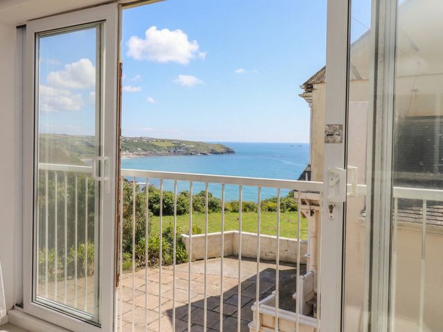 A balcony with glass doors overlooking the sea at Brook House Sennen Cove near St Just