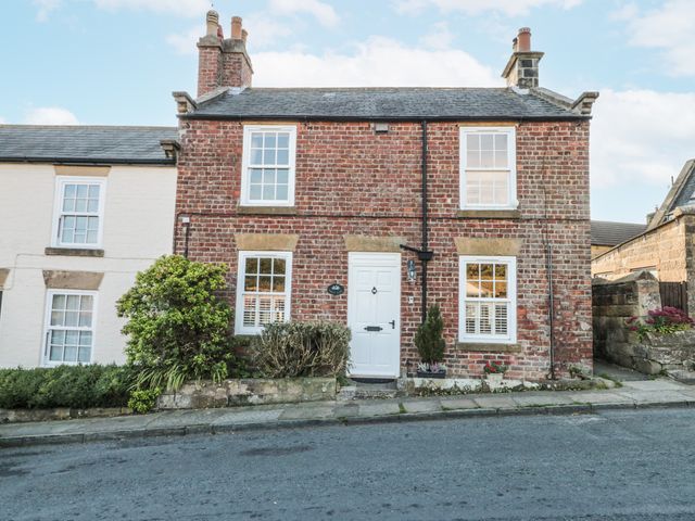 A brick house with windows and a door at Croft View in Fylingthorpe near Robin Hood's Bay