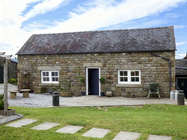 A stone building with windows and a door in front at Little Owl Barn Longnor