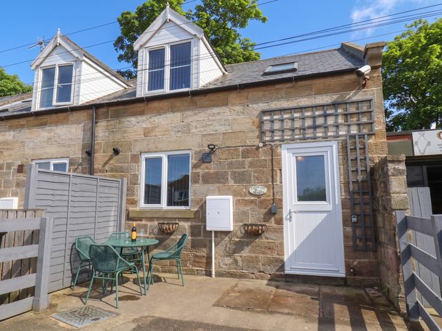 An outdoor seating area with a table and chairs at Fortunatus in Whitby