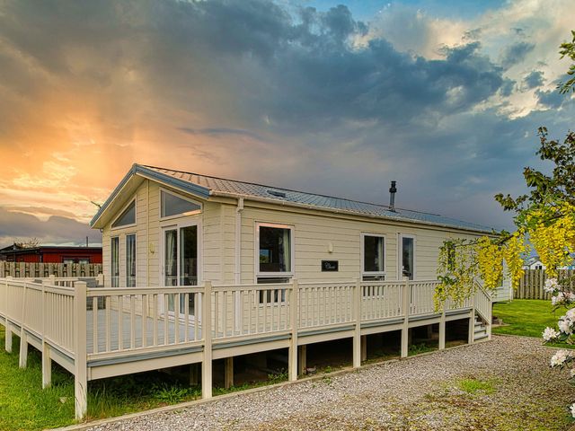 A house with a deck and garden at Cheri in Southerness