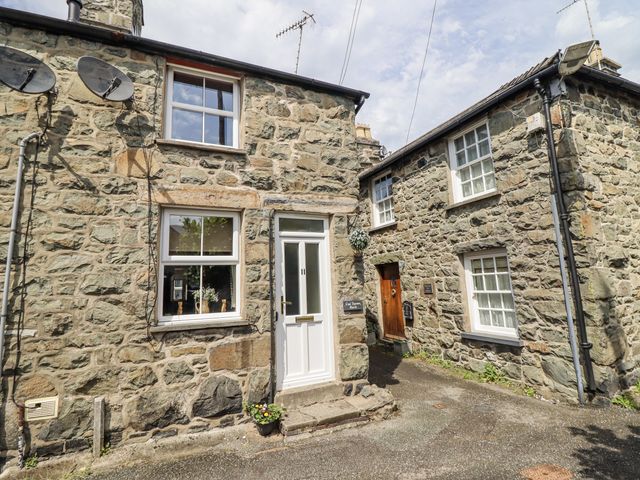 An outdoor area featuring stone houses and a pathway at Cae Tanws Bach Dolgellau