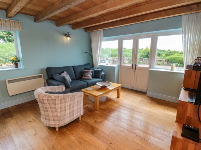 A living room with a sofa and coffee table at Field Cottage in Staithes
