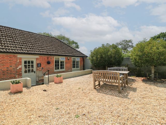 An outdoor area with a table and chairs at The Cider Press, Motcombe