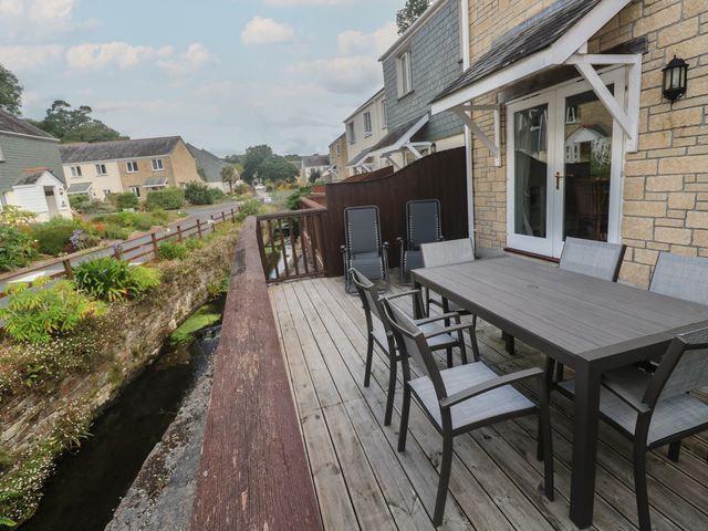 An outdoor area with a table and chairs at Rosemary Cottage in Falmouth