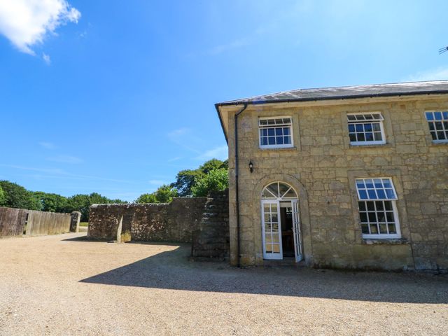 A building with a door and windows at The Stable Cottage in Wroxall