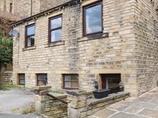 An outdoor area with stone walls and windows at Half Under 