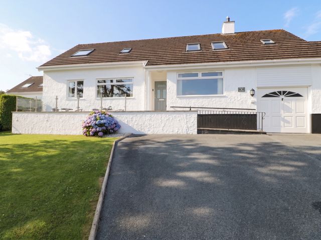 A house with a garage and garden at Bay View in Benllech
