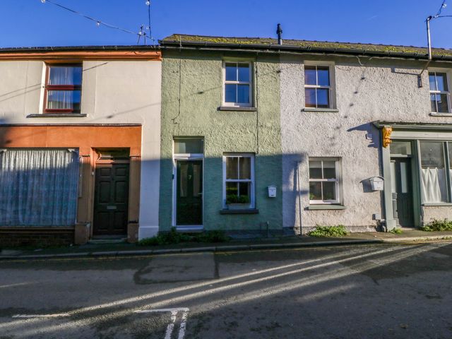 A row of terraced houses with various colored facades at 7 Bell Street in Talgarth